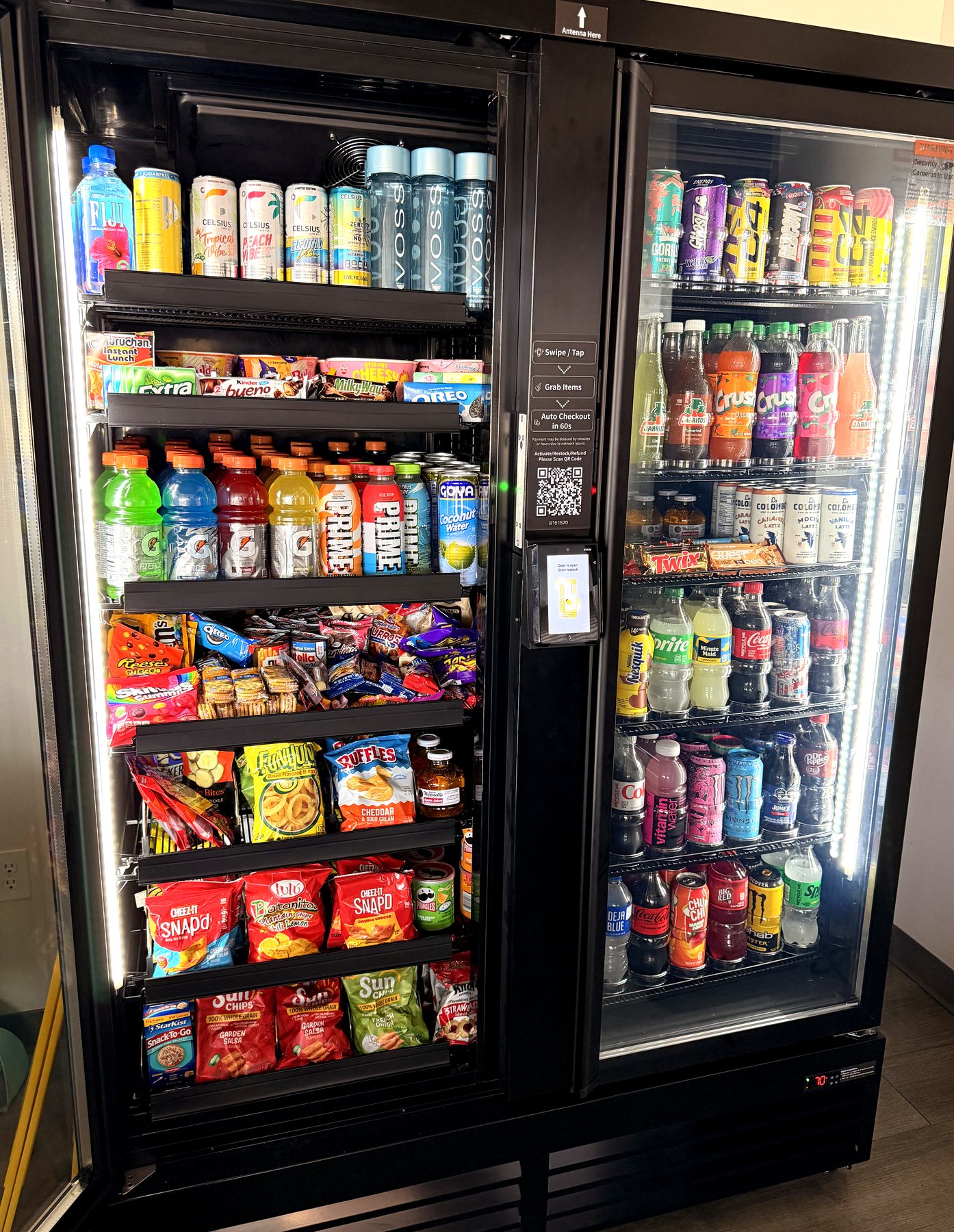 Two-door AI smart cooler stocked with snacks and drinks, with a swipe-and-grab checkout panel in the center